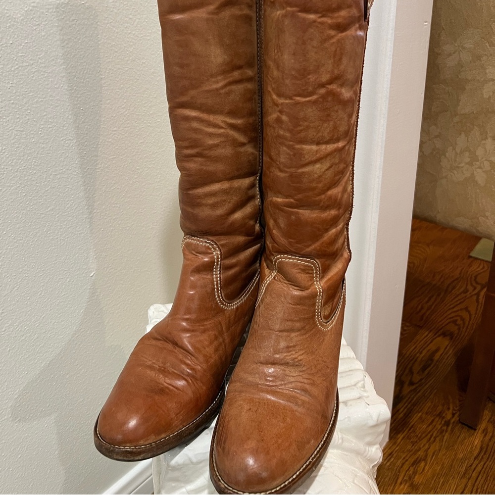 Authentic leather Coach tall boot with decorative toggle. In great condition.